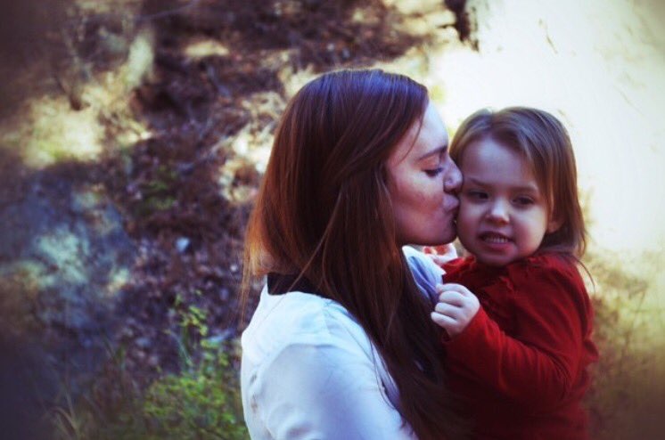 Skylar Blasingame gives little sister, Nevaek, a smooch