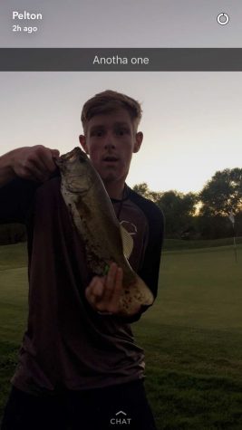 Brandon Pelton holds up his catch