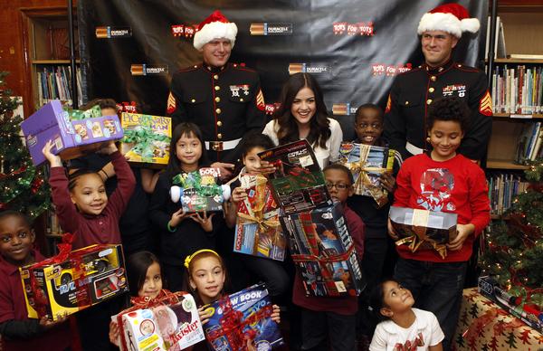 Actress Lucy Hale kicks off the Duracell Power Holiday Smiles program to benefit Toys for Tots by making a surprise visit with battery-operated toys for students at P.S. 64, Tuesday, Nov. 20, 2012, in New York.  The program aims to power 500,000 smiles for families in need with the help of consumers.  Visit Facebook.com/Durecell for more information. (Photo by Jason DeCrow for Duracell)