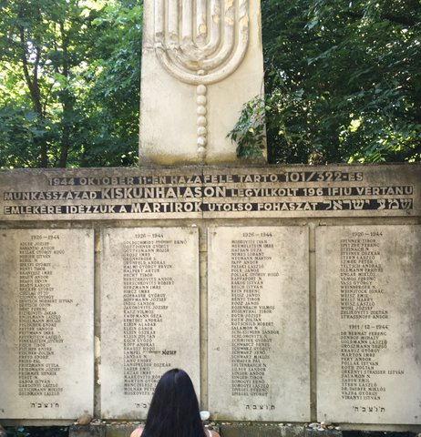 Ms. Lange in front of her father's Holocaust Memorial