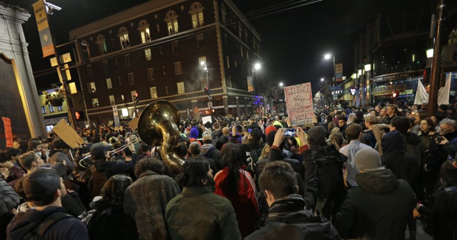 Protesters against a scheduled speaking appearance by Breitbart News editor Milo Yiannopoulos on the University of California at Berkeley campus march Wednesday, Feb. 1, 2017, on Telegraph Avenue in Berkeley, Calif. The event was cancelled due to size of the crowd and several fires set. (AP Photo/Ben Margot) ORG XMIT: CABM117