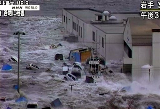 Video image taken from Japan's NHK TV March 11, 2011 following the earthquake, a tsunami hits against a building in Miyaku City.