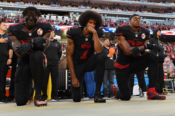 SANTA CLARA, CA - OCTOBER 06:  (L-R) Eli Harold #58, Colin Kaepernick #7, and Eric Reid #35 of the San Francisco 49ers kneel in protest during the national anthem prior to their NFL game against the Arizona Cardinals at Levi's Stadium on October 6, 2016 in Santa Clara, California.  (Photo by Thearon W. Henderson/Getty Images)