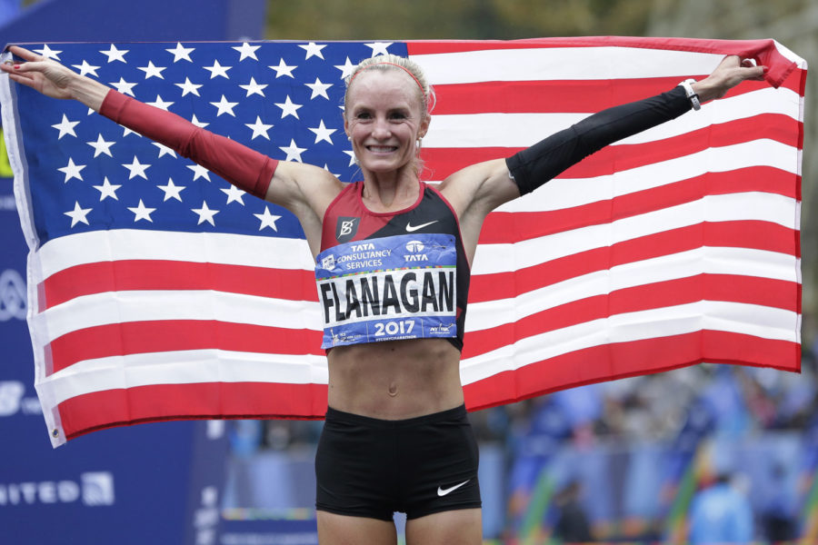 Shalane Flanagan of the United States poses for pictures after crossing the finish line first in the women's division of the New York City Marathon in New York, Sunday, Nov. 5, 2017. (AP Photo/Seth Wenig)