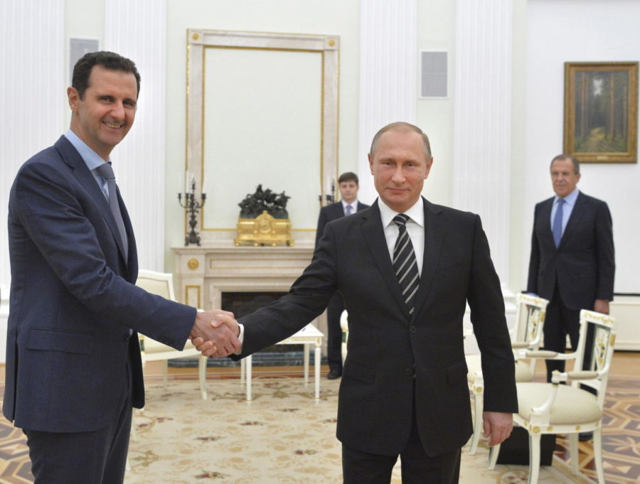 Russian President Vladimir Putin (R) shakes hands with Syrian President Bashar al-Assad during a meeting at the Kremlin in Moscow, Russia, in this October 20, 2015 file photo. To match Insight MIDEAST-CRISIS-SYRIA/PUTIN REUTERS/Alexei Druzhinin/RIA Novosti/Kremlin/ Files ATTENTION EDITORS - THIS IMAGE HAS BEEN SUPPLIED BY A THIRD PARTY. IT IS DISTRIBUTED, EXACTLY AS RECEIVED BY REUTERS, AS A SERVICE TO CLIENTS. TPX IMAGES OF THE DAY      - RTX28OUJ