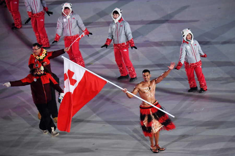 PYEONGCHANG-GUN, SOUTH KOREA - FEBRUARY 09:  Flag bearer Pita Taufatofua of Tonga and teammates enter the stadium during the Opening Ceremony of the PyeongChang 2018 Winter Olympic Games at PyeongChang Olympic Stadium on February 9, 2018 in Pyeongchang-gun, South Korea.  (Photo by Pool - Frank Fife/Getty Images)