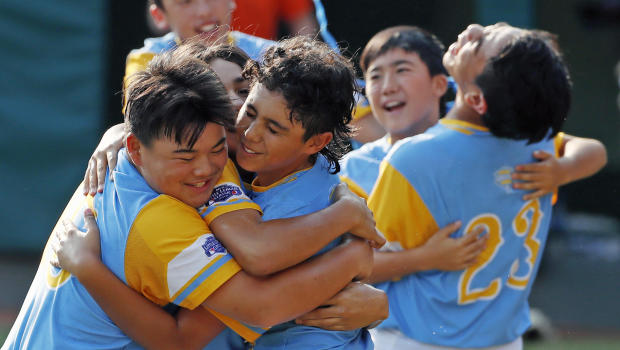 Honolulu pitcher Ka'olu Holt (center) congratulated by teammates. 
Photo Credit: CBS Sports