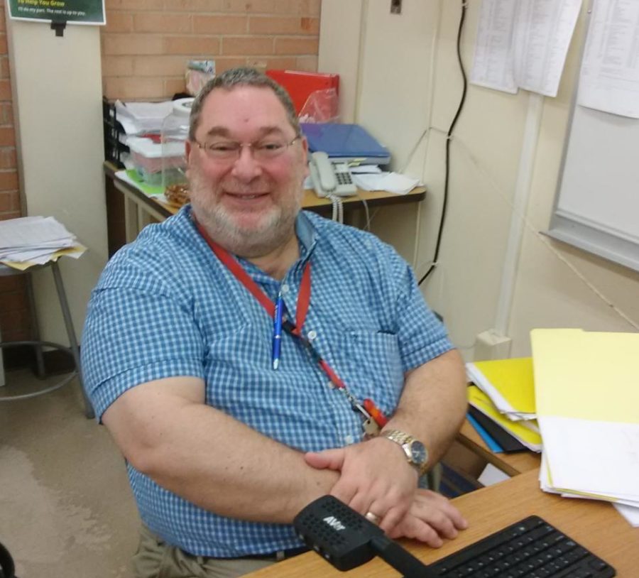 Mr. Bellows (survivor) working at his desk in his classroom 