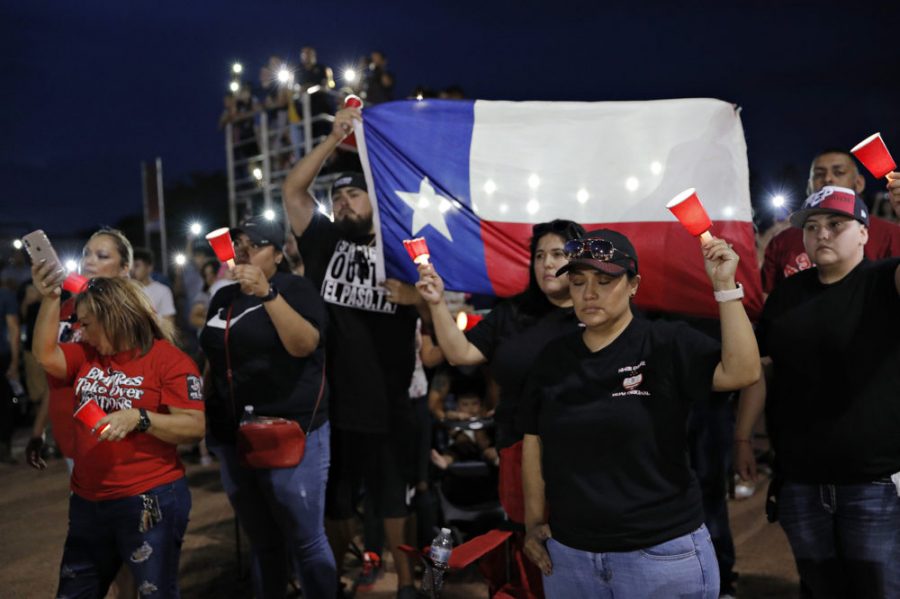 People attend a vigil for victims of Saturday's mass shooting at a shopping complex Sunday, Aug. 4, 2019, in El Paso, Texas. (AP Photo/John Locher)