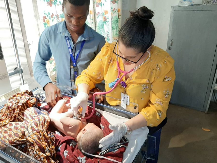 Dr. Sommer checking a baby's heart beat in the Tanzanian hospital. 