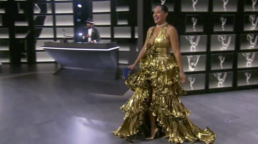 Tracee Ellis Ross is a female actress. She wore this statement piece to the Emmys. She dressed "as her own trophy." Although there is a back story to the dress, the dress is not the best. It is definitely a statement piece but the gold and the ruffles are too busy. We love the acting, but not the dress.