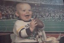 Football lover since Day 1. He's got the jersey and football and everything!