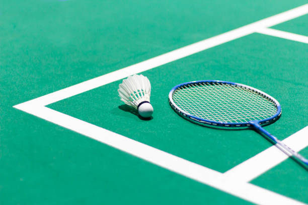 badminton balls and badminton rackets Shuttlecock in green badminton court used in competition