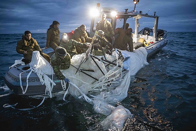 Sailors assigned to Explosive Ordnance Disposal Group 2 recover a high-altitude surveillance balloon off the coast of Myrtle Beach, South Carolina, Feb. 5, 2023. EODGRU 2 is a critical part of the Navy Expeditionary Combat Force that clears explosive hazards to provide access to denied areas; secures the undersea domain for freedom of movement; builds and fosters relationships with trusted partners, and protects the homeland. At the direction of the President of the United States and with the full support of the Government of Canada, U.S. fighter aircraft under U.S. Northern Command authority engaged and brought down a high altitude surveillance balloon within sovereign U.S. airspace and over U.S. territorial waters Feb. 4, 2023.  Active duty, Reserve, National Guard, and civilian personnel planned and executed the operation, and partners from the U.S. Coast Guard, Federal Aviation Administration, and Federal Bureau of Investigation ensured public safety throughout the operation and recovery efforts.  (U.S. Navy Photo by Mass Communication Specialist 1st Class Tyler Thompson)