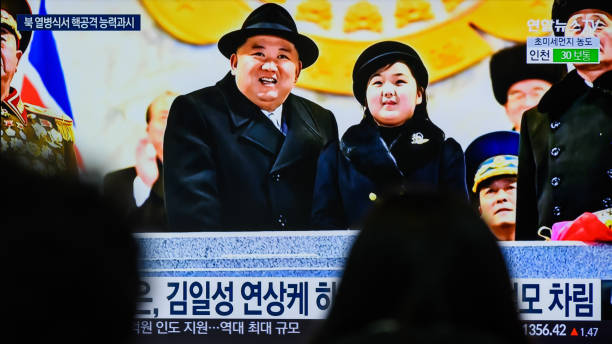 SEOUL, SOUTH KOREA - 2023/02/09: People watch a television screen showing a news broadcast with an image of North Korean leader Kim Jong-un (L) and his daughter presumed to be named Ju-ae (R) attending a military parade held in Pyongyang to mark the 75th founding anniversary of its armed forces, at Yongsan railway station in Seoul. North Korea has staged a massive military parade in Pyongyang to mark the 75th founding anniversary of its armed forces, its state media confirmed on February 9, describing intercontinental ballistic missiles (ICBMs) on display as representing the country's "maximum nuclear attack capabilities."
Its leader Kim Jong-un attended the nighttime event, held February 8, along with his wife, Ri Sol-ju, and apparent second child, Ju-ae, according to the North's official Korean Central News Agency (KCNA). (Photo by Kim Jae-Hwan/SOPA Images/LightRocket via Getty Images)