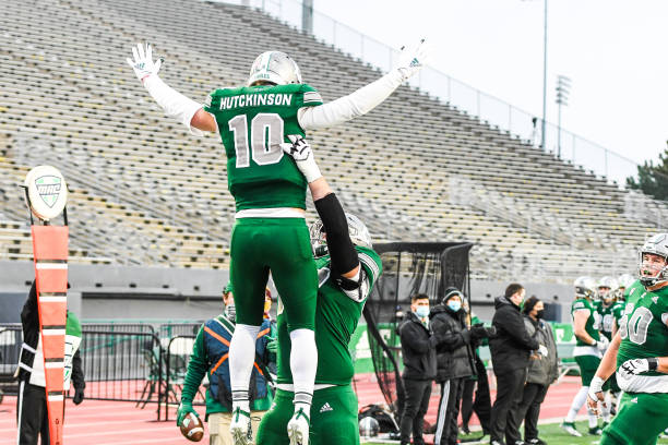 YPSILANTI, MI - NOVEMBER 27: Eastern Michigan Eagles quarterback Preston Hutchinson (10) celebrates his touchdown with Eastern Michigan Eagles offensive lineman Brian Dooley (77) during the Eastern Michigan Eagles vs Central Michigan Chippewas game on Friday November 27, 2020 at Rynearson Stadium in Ypsilanti, MI (Photo by Steven King/Icon Sportswire via Getty Images)