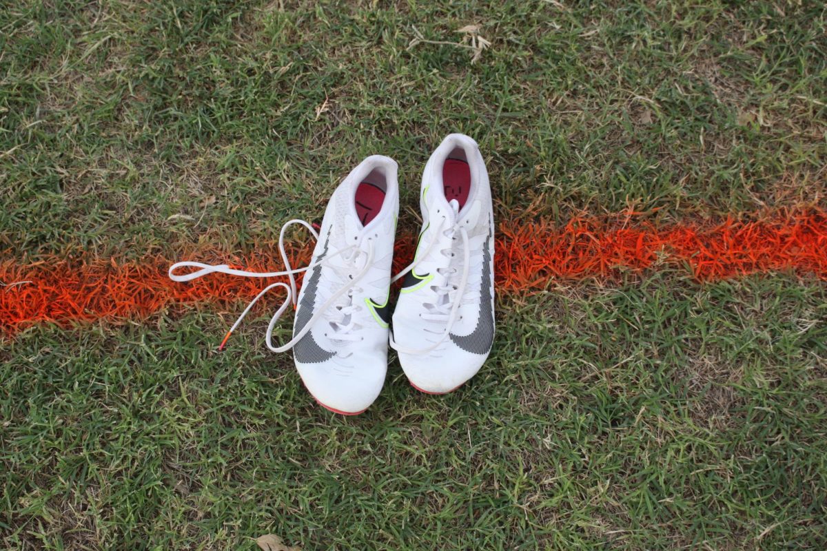 Adam's shoes placed backwards on the start line before the meet