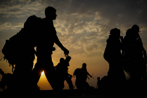 Immigrants walking before sunset