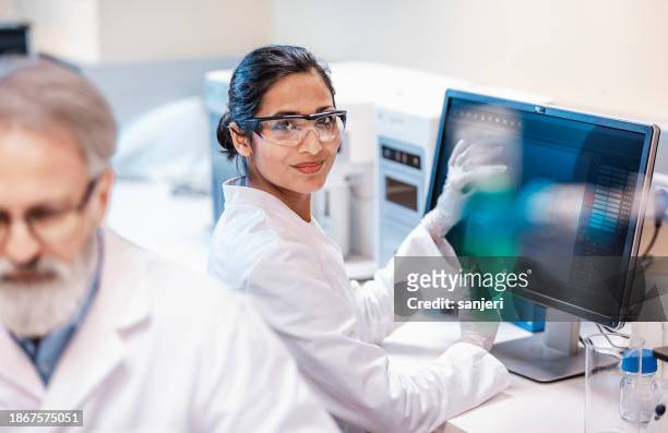 Female Scientist Working in The Lab, Using Computer