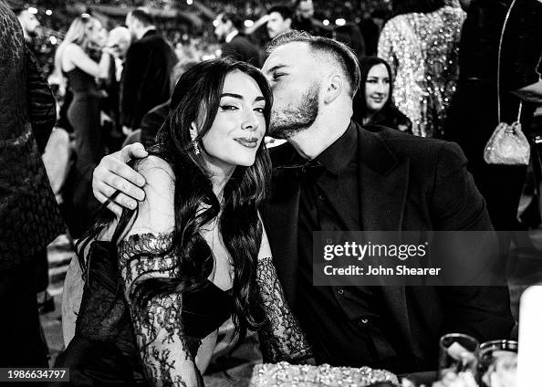 LOS ANGELES, CALIFORNIA - FEBRUARY 04: (EDITORS NOTE: Image has been converted to black and white.) (L-R) Brianna LaPaglia and Zach Bryan attend the 66th GRAMMY Awards on February 04, 2024 in Los Angeles, California. (Photo by John Shearer/Getty Images for The Recording Academy)