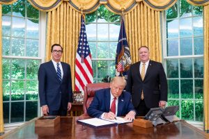 	
English: President Donald J. Trump, joined by Secretary of the Treasury Steven Mnuchin and Secretary of State Mike Pompeo, signs the unanimously approved H.R. 7440, the Hong Kong Autonomy Act and "The President’s Executive Order on Hong Kong Normalization", Tuesday, July 14, 2020, at his desk in the Oval Office of the White House. (Official White House Photo by Tia Dufour)