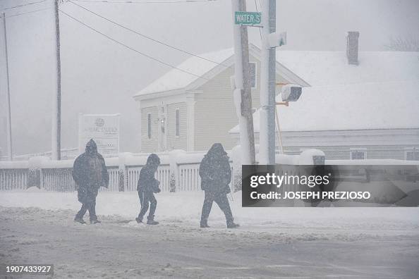 People walk through the snowstorm in Lawrence, Massachusetts on January 7, 2024. Forecasters warned on January 5 that a deluge of snow and wintery conditions could bring travel chaos to the US northeast this weekend, with some 25 million people subject to a storm warning. (Photo by Joseph Prezioso / AFP) (Photo by JOSEPH PREZIOSO/AFP via Getty Images)