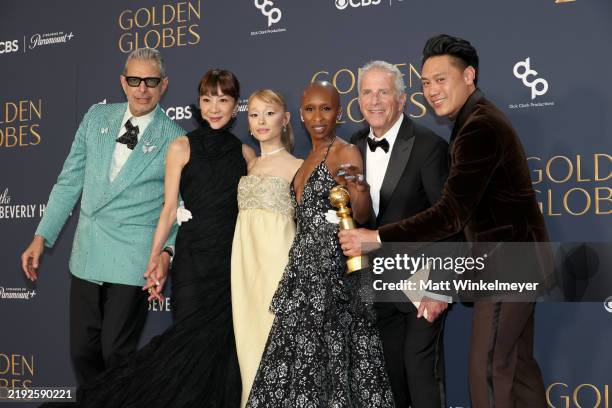 BEVERLY HILLS, CALIFORNIA - JANUARY 05: (L-R) Jeff Goldblum, Michelle Yeoh, Ariana Grande, Cynthia Erivo, Marc E. Platt and Jon M. Chu, winner of the Cinematic and Box Office Achievement Award for "Wicked" pose in the press room during the 82nd Annual Golden Globe Awards at The Beverly Hilton on January 05, 2025 in Beverly Hills, California.  (Photo by Matt Winkelmeyer/WireImage)