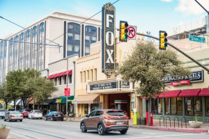 Cars drive past Fox theater in downtown Tucson Arizona USA on a cloudy day.