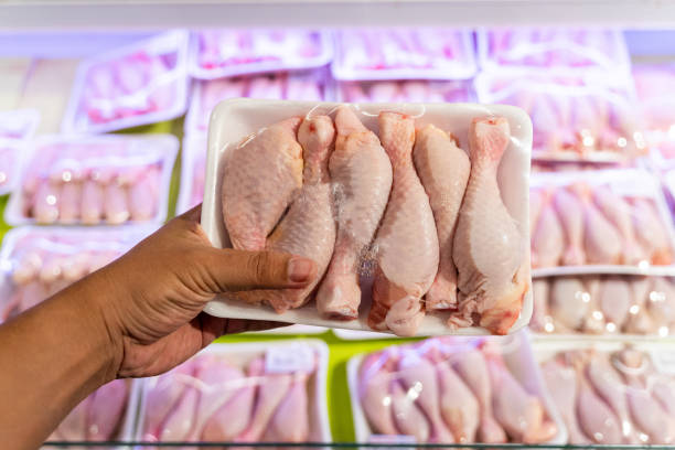 Point of View Hand Holding  Chicken  in a grocery store
